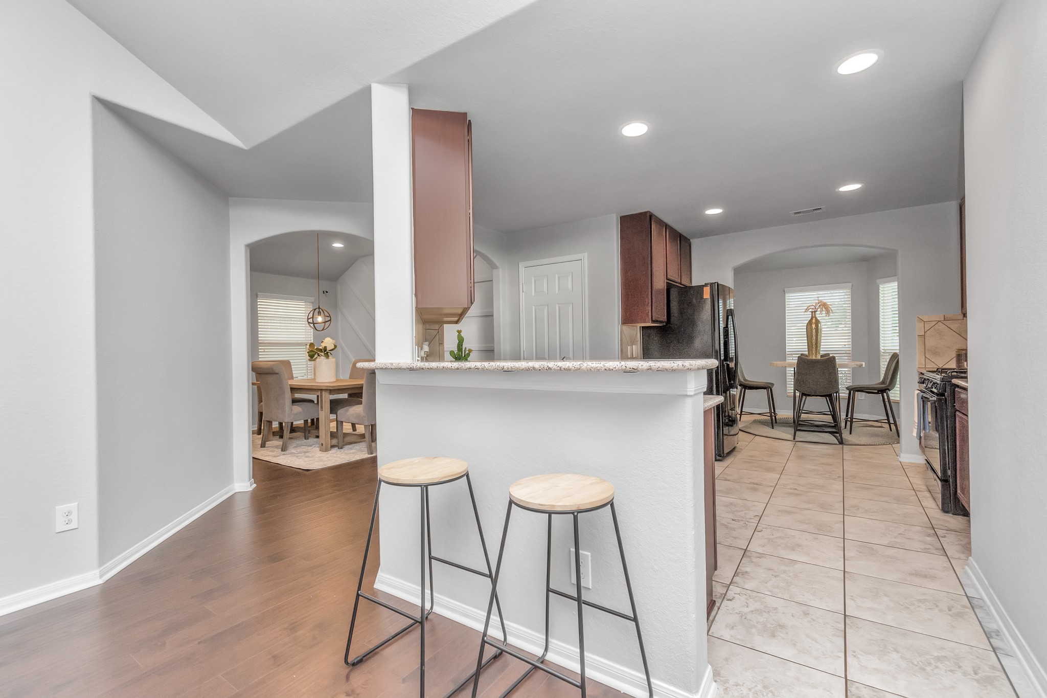 2411 Zephyr Lane Rosenberg, TX 77471 - Photo 6 of 20 a kitchen with stainless steel appliances kitchen island granite countertop a table and chairs in it