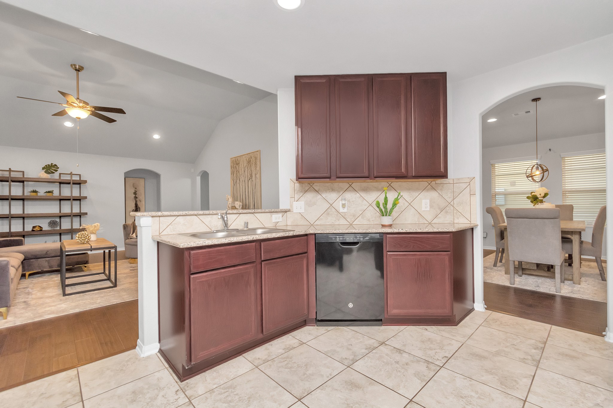 2411 Zephyr Lane Rosenberg, TX 77471 - Photo 7 of 20 a kitchen with kitchen island granite countertop a sink and a stove
