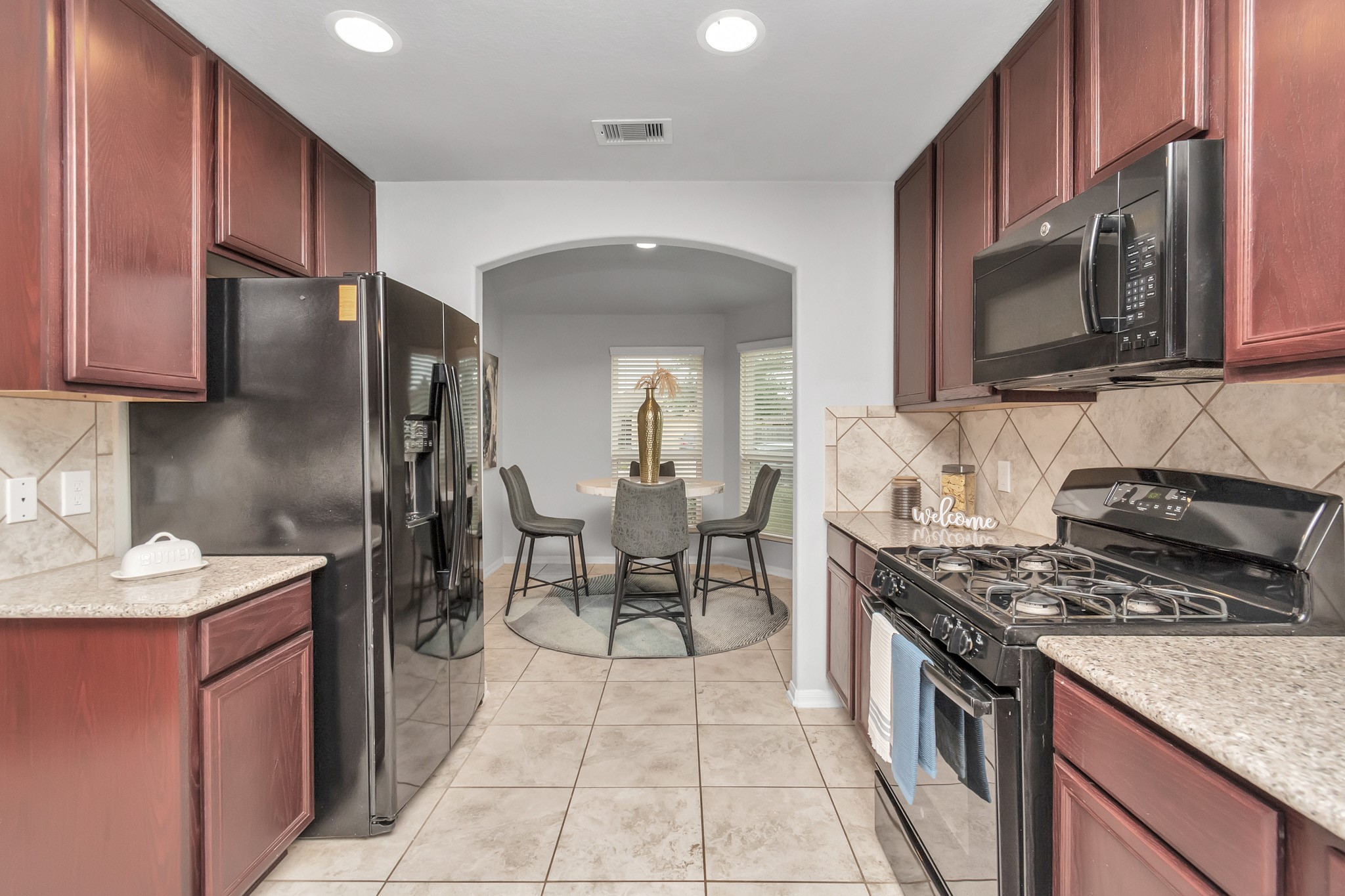 2411 Zephyr Lane Rosenberg, TX 77471 - Photo 8 of 20 a kitchen with stainless steel appliances granite countertop a sink stove and refrigerator