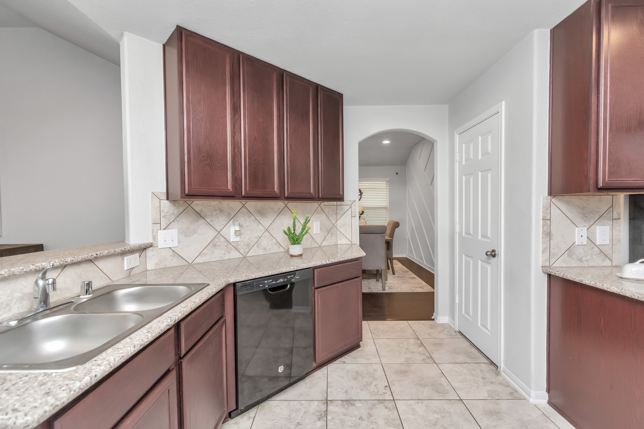 2411 Zephyr Lane Rosenberg, TX 77471 - Photo 9 of 20 a kitchen with a sink stove and cabinets