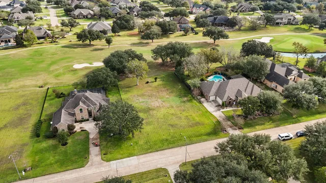 an aerial view of residential houses with outdoor space and swimming pool