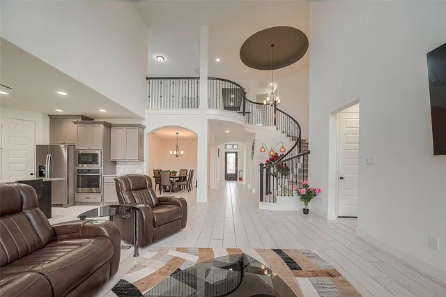 a living room with furniture and a chandelier