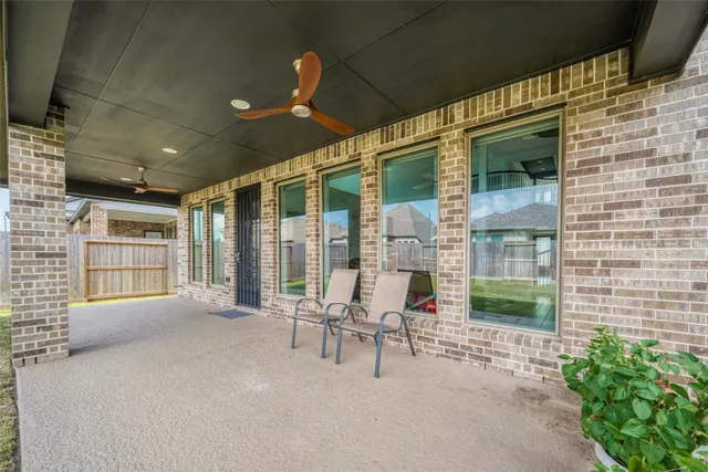 a balcony with furniture and large windows