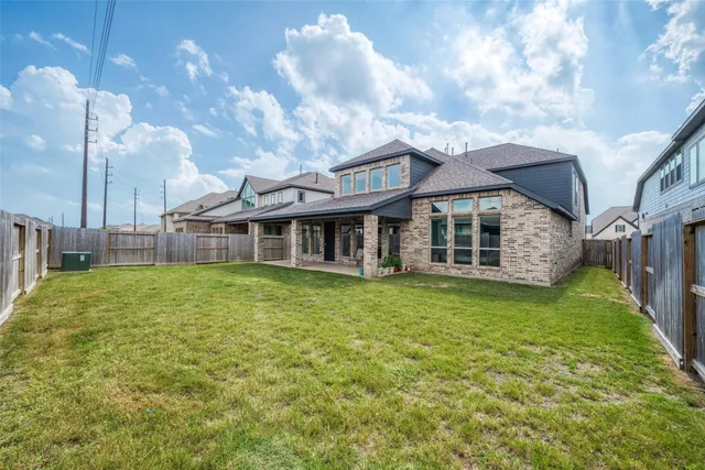 a view of a house with a backyard