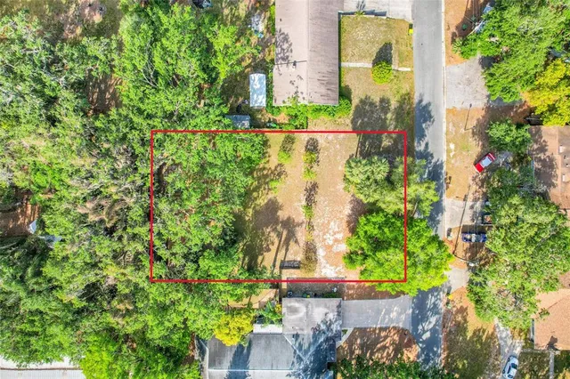 an aerial view of a house with a yard and garden