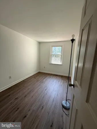 a view of room with wooden floor and window