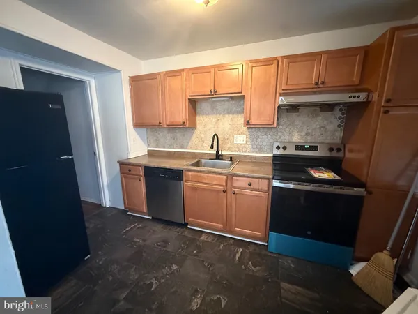 a kitchen with a sink stove and refrigerator