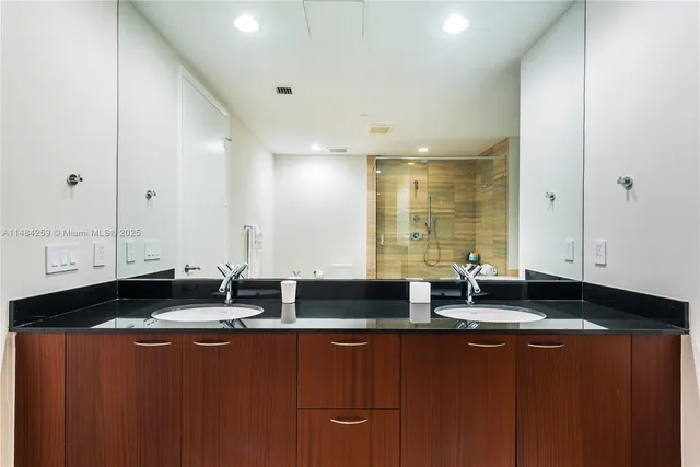 a view of large mirror and cabinets