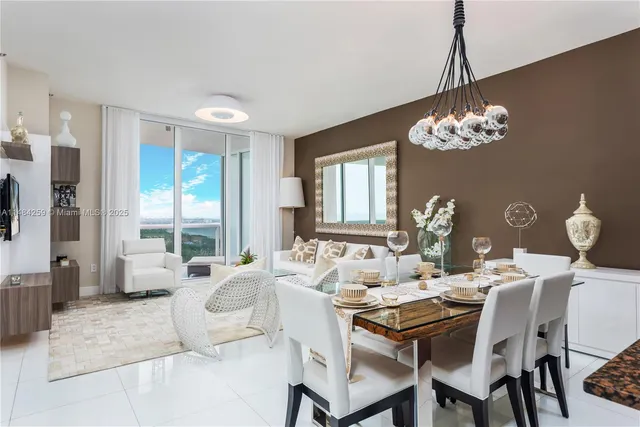 a view of a dining room with furniture wooden floor and chandelier