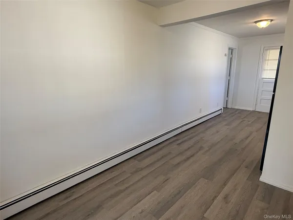 a view of wooden floor in an empty room