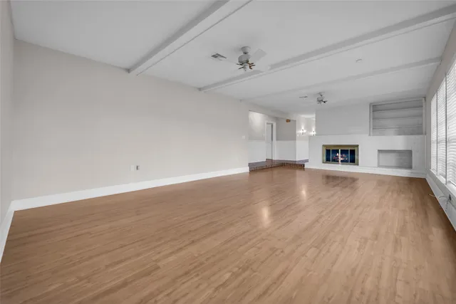 a view of a room with wooden floor