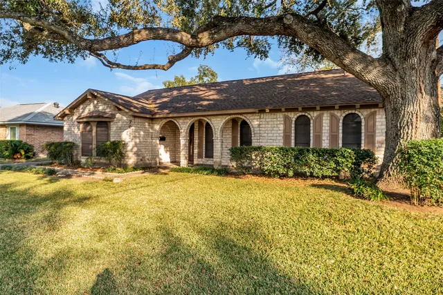 an aerial view of a house with a garden and swimming pool
