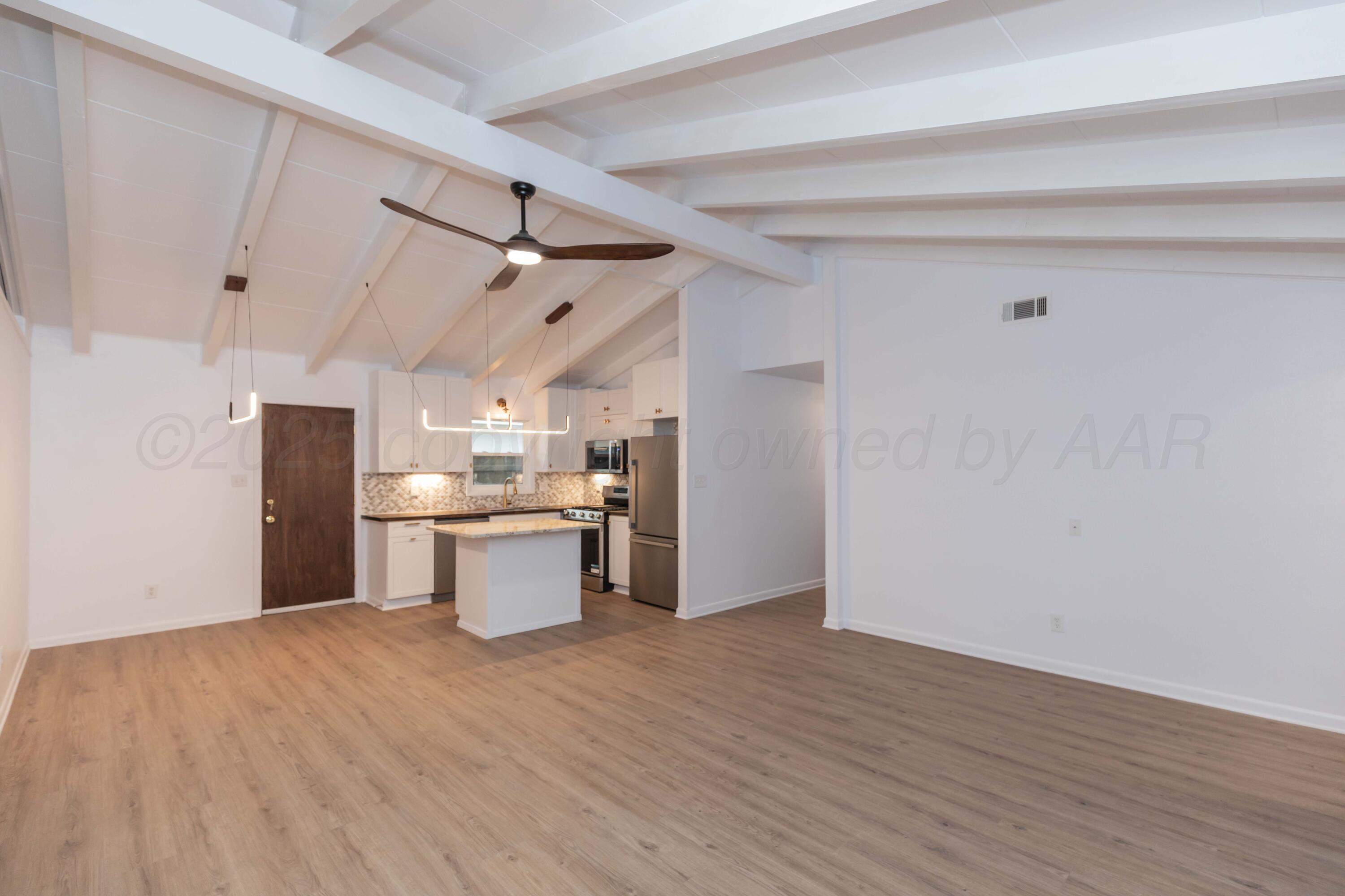 4708 South Lamar Street Amarillo, TX 79110 - Photo 13 of 40 a kitchen with a sink cabinets and wooden floor