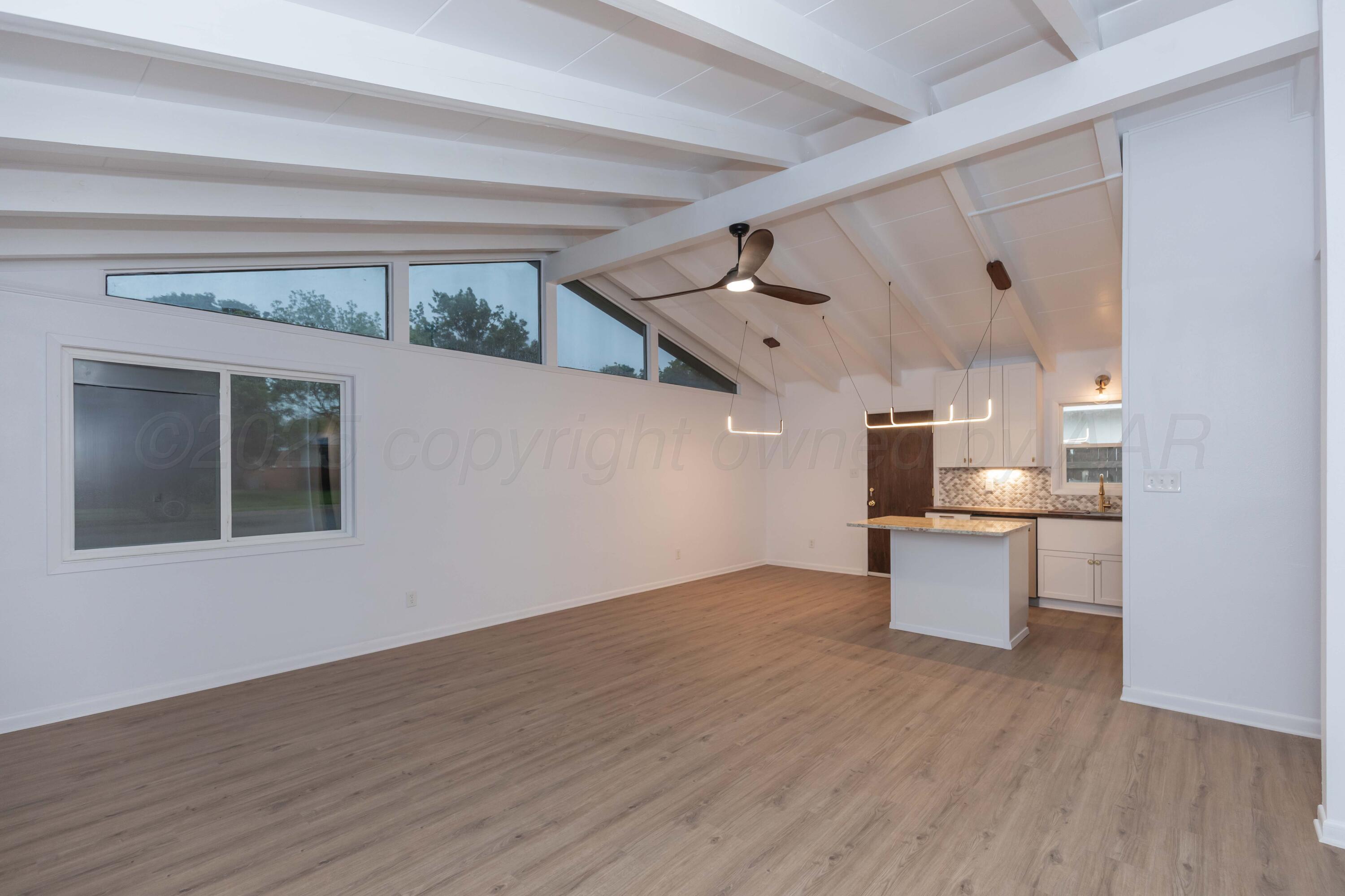 4708 South Lamar Street Amarillo, TX 79110 - Photo 14 of 40 a view of a kitchen with a sink and wooden floor