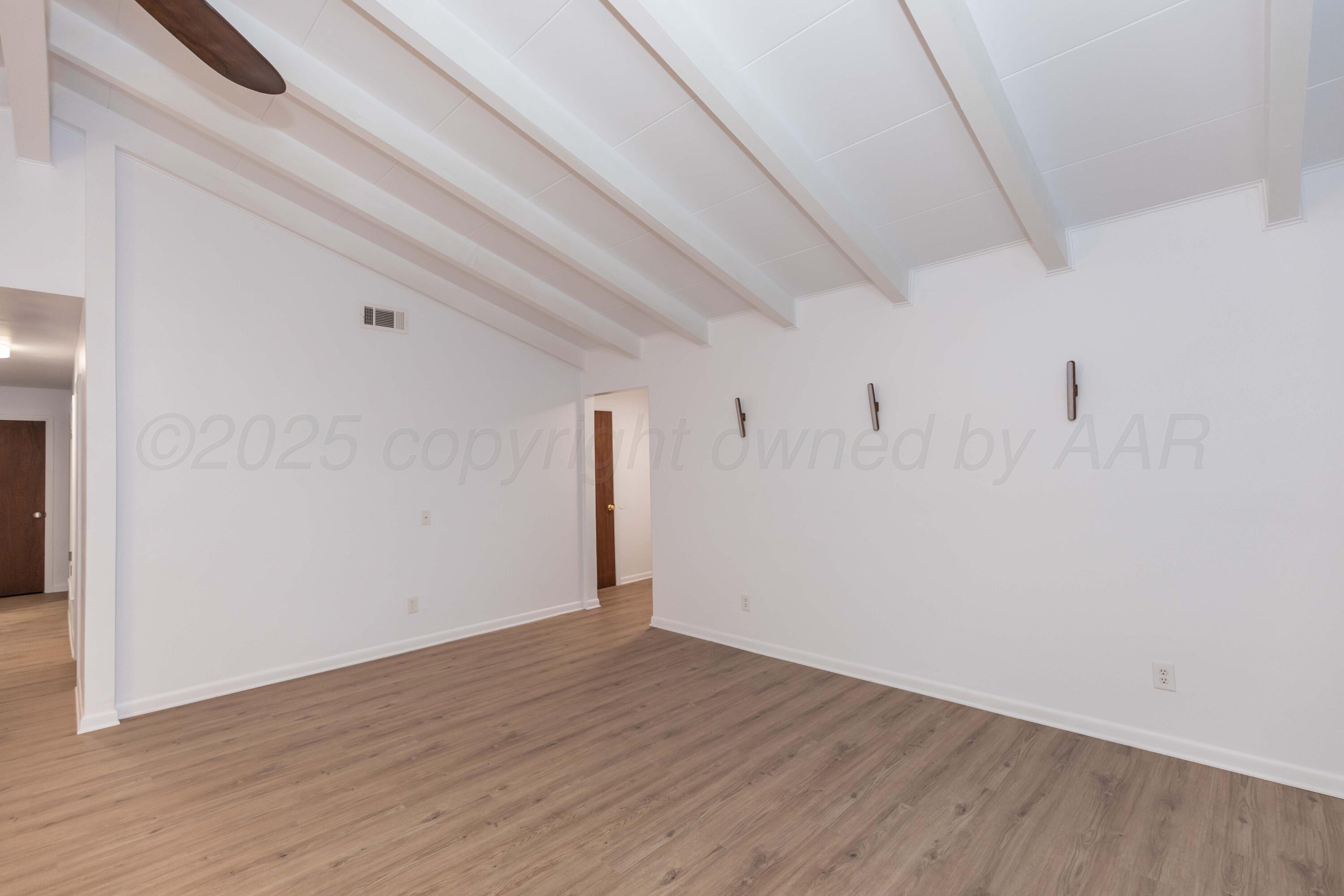 4708 South Lamar Street Amarillo, TX 79110 - Photo 16 of 40 a view of empty room with wooden floor