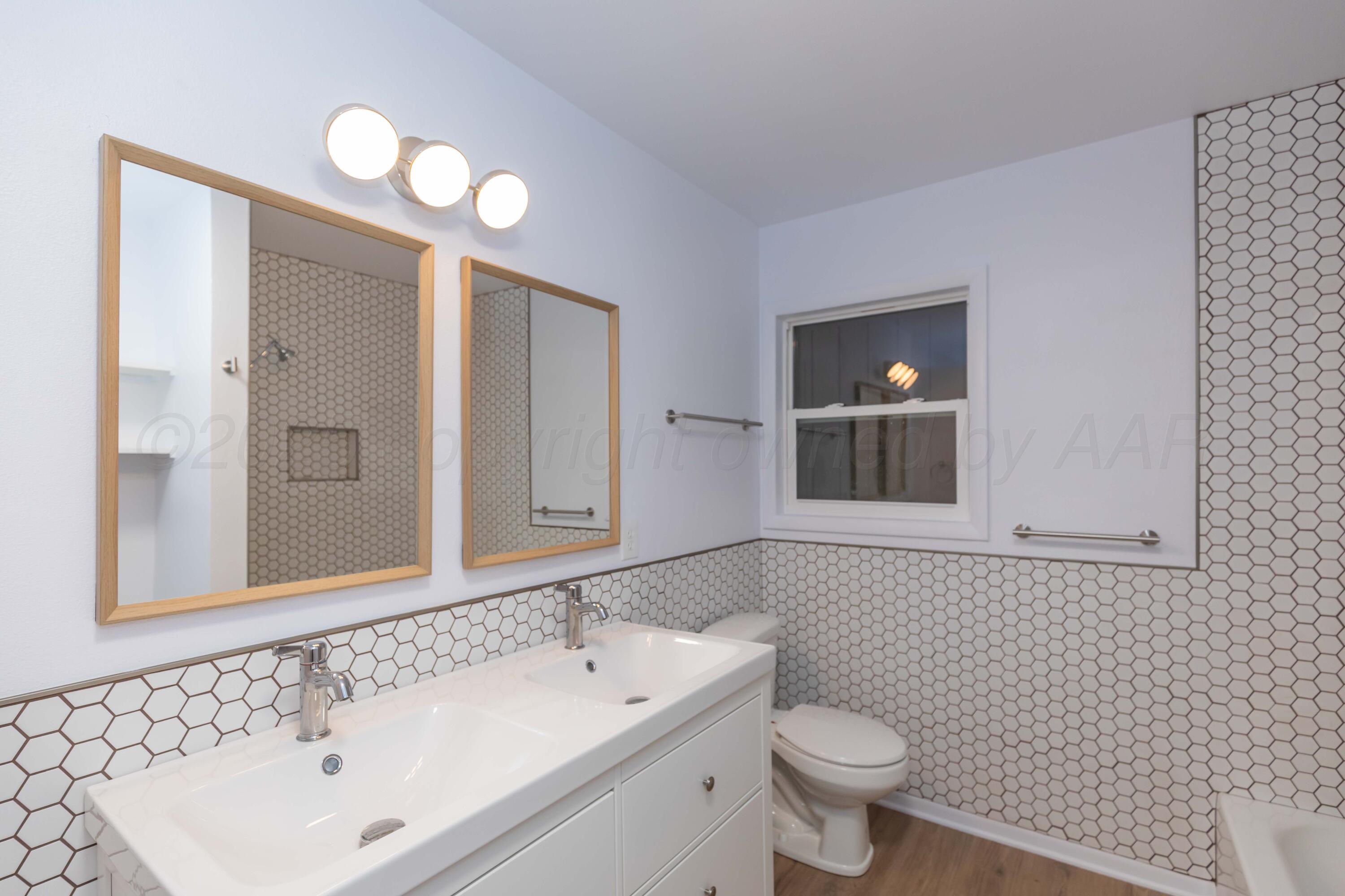 4708 South Lamar Street Amarillo, TX 79110 - Photo 17 of 40 a bathroom with a sink and a toilet