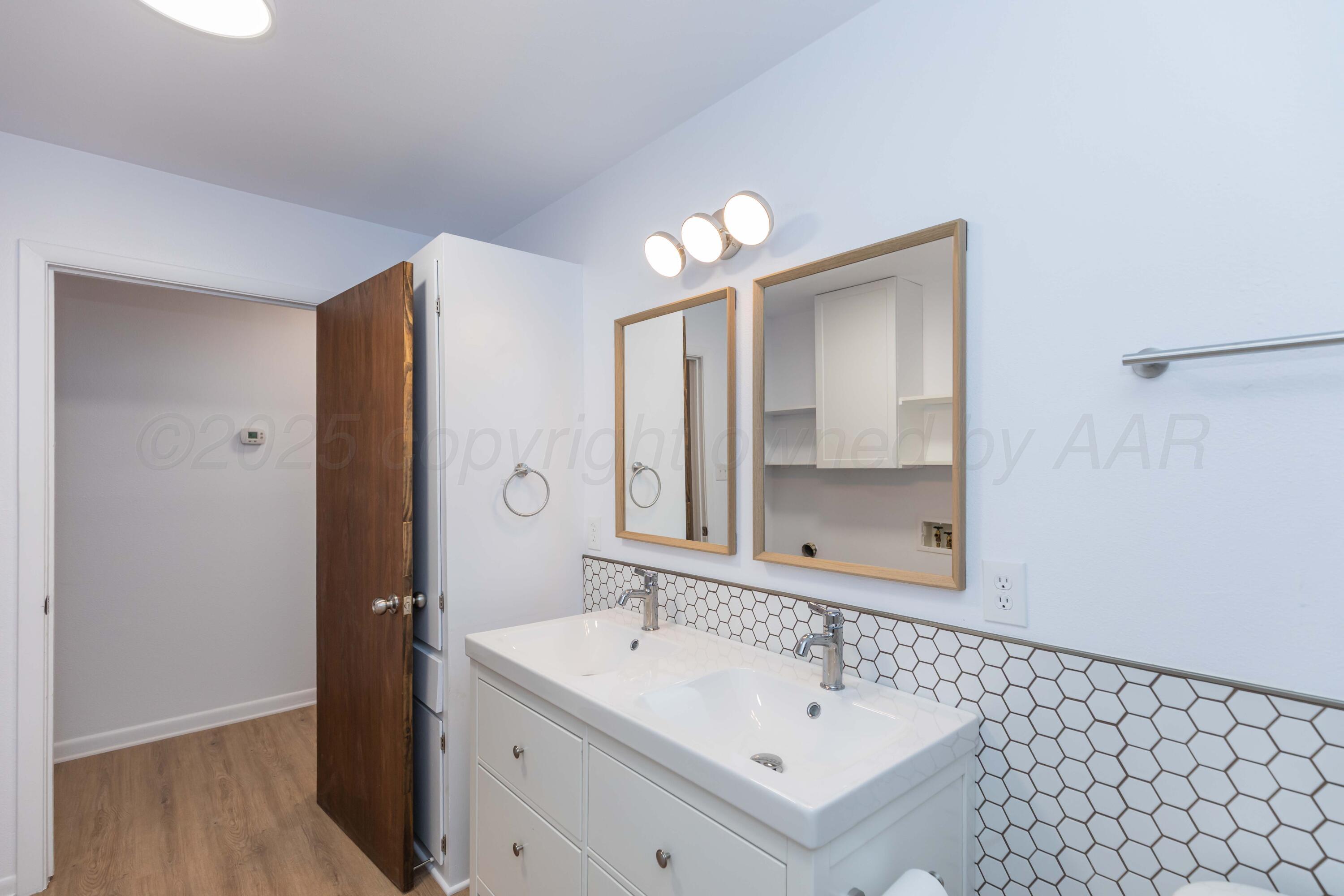 4708 South Lamar Street Amarillo, TX 79110 - Photo 18 of 40 a bathroom with a sink and a mirror