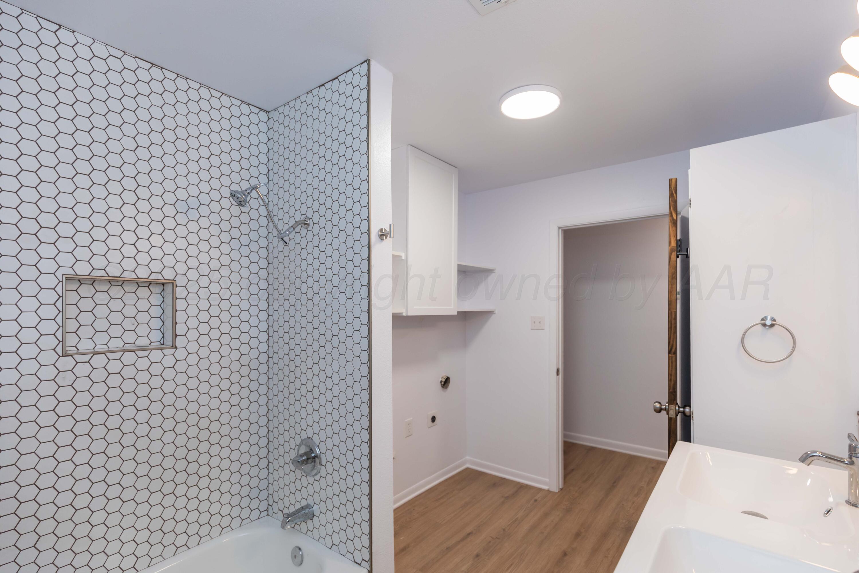 4708 South Lamar Street Amarillo, TX 79110 - Photo 19 of 40 a bathroom with a bathtub and shower