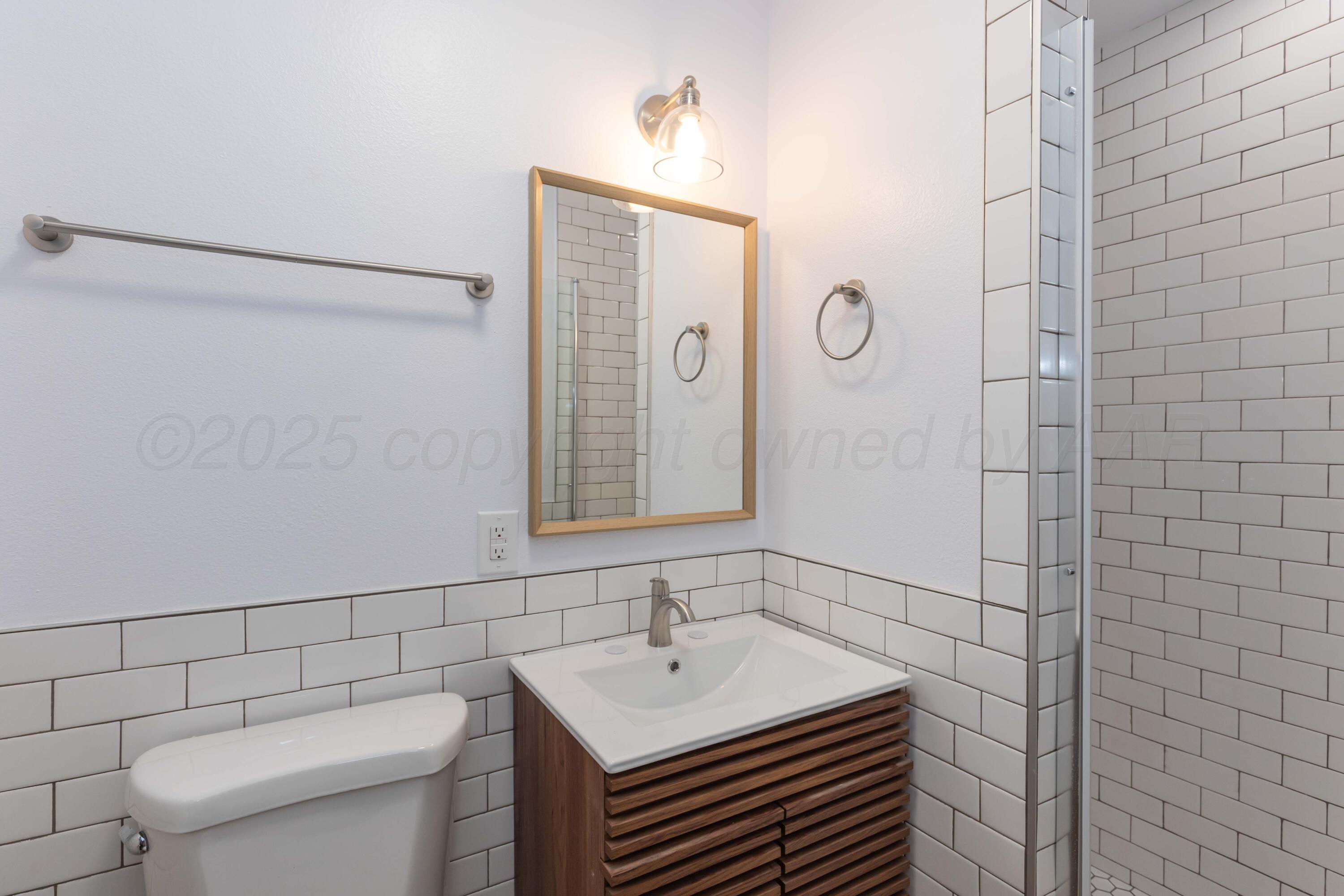 4708 South Lamar Street Amarillo, TX 79110 - Photo 24 of 40 a bathroom with a sink a toilet and shower