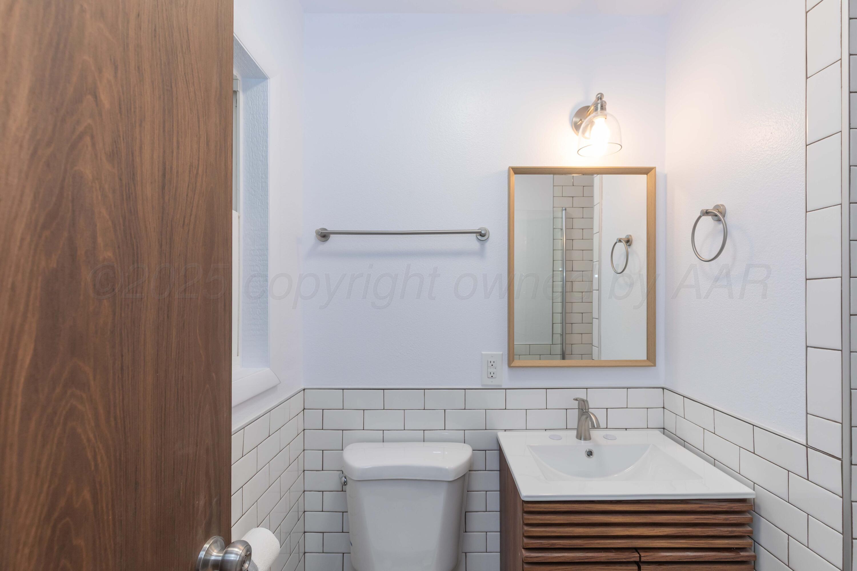 4708 South Lamar Street Amarillo, TX 79110 - Photo 26 of 40 a bathroom with a sink and a mirror