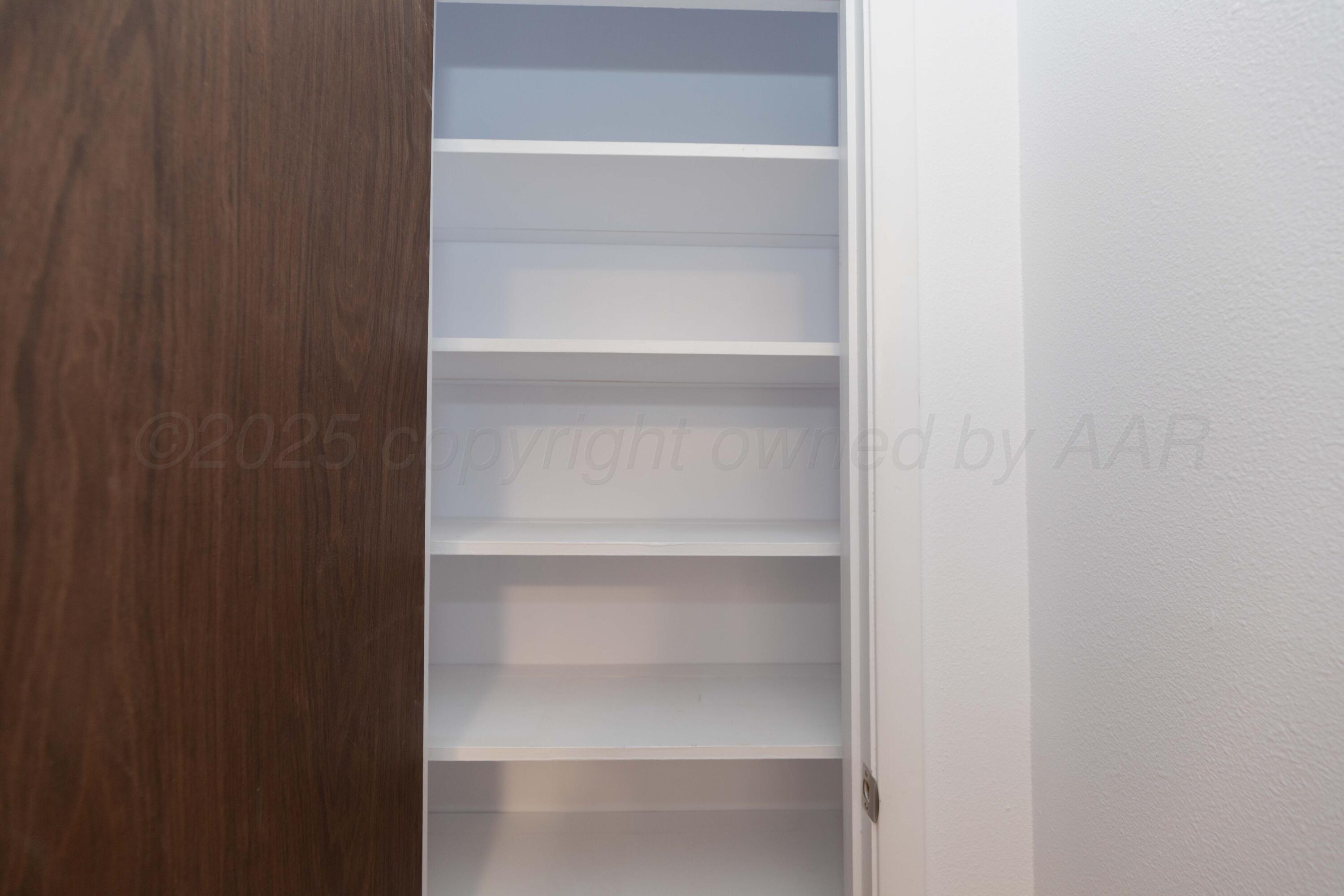 4708 South Lamar Street Amarillo, TX 79110 - Photo 28 of 40 a view of walk in closet with empty racks