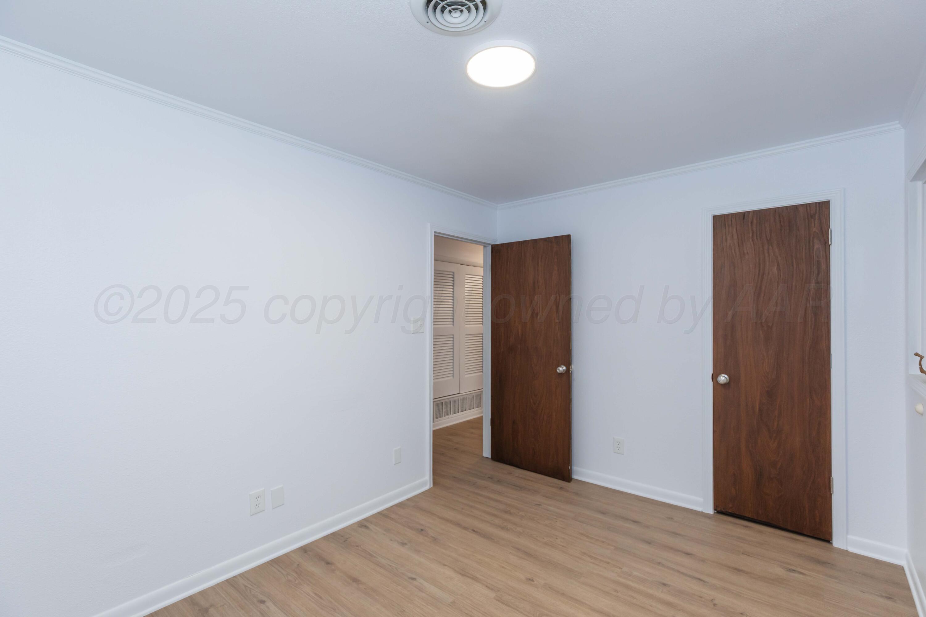 4708 South Lamar Street Amarillo, TX 79110 - Photo 31 of 40 a view of an empty room with wooden floor