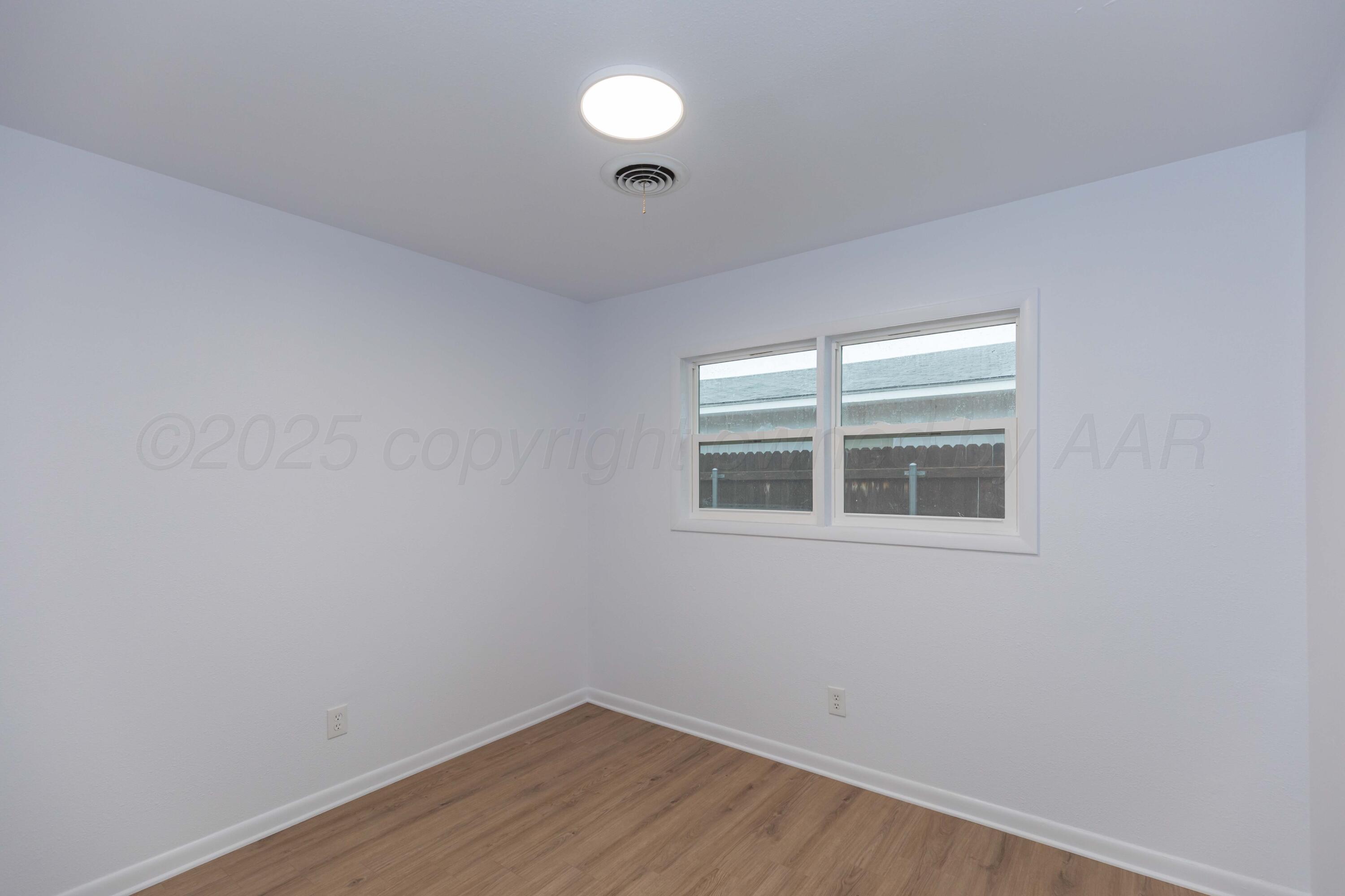 4708 South Lamar Street Amarillo, TX 79110 - Photo 33 of 40 a view of empty room with wooden floor and fan
