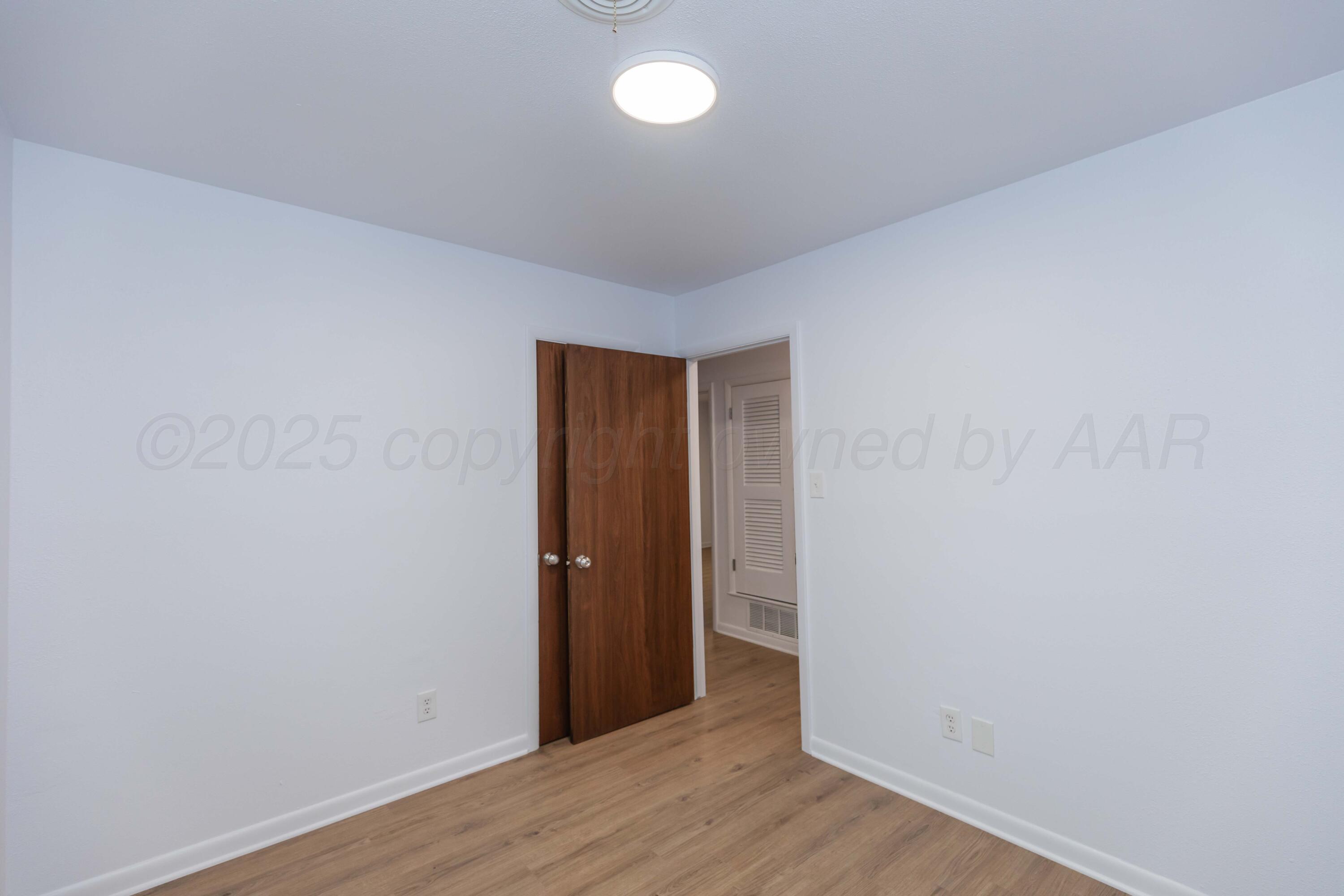 4708 South Lamar Street Amarillo, TX 79110 - Photo 35 of 40 a view of an empty room with wooden floor and a window