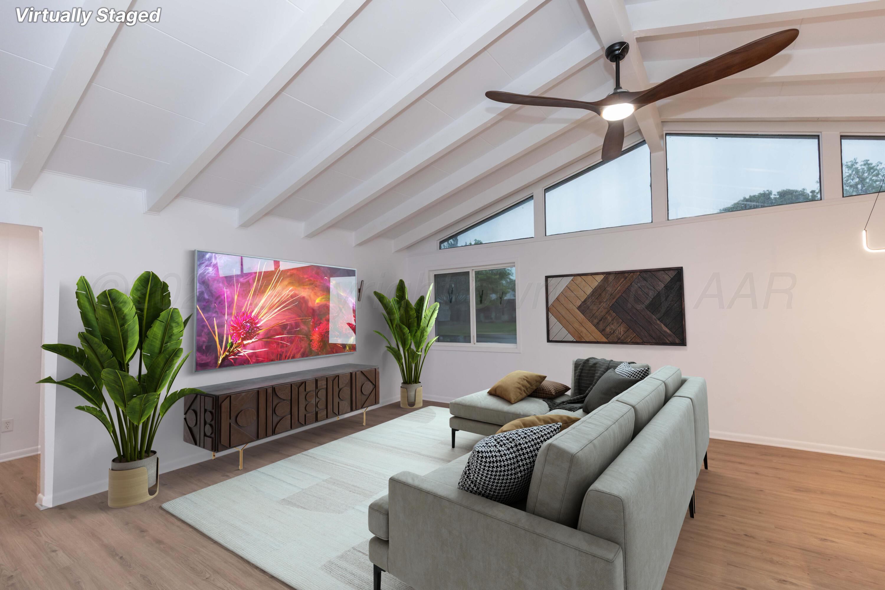 4708 South Lamar Street Amarillo, TX 79110 - Photo 10 of 40 a living room with furniture a fireplace and a flat screen tv