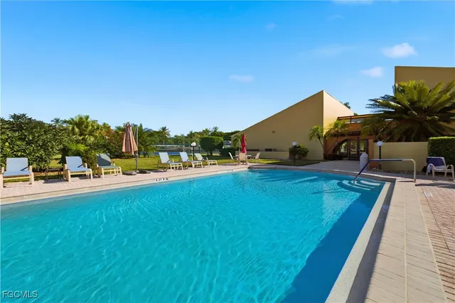 a view of swimming pool with outdoor seating and deck