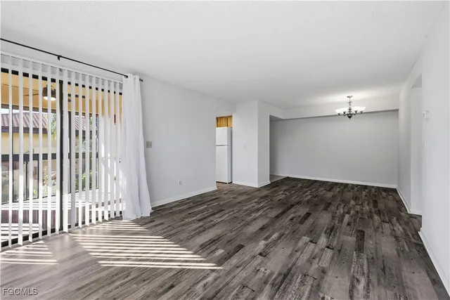 a view of a bedroom with wooden floor