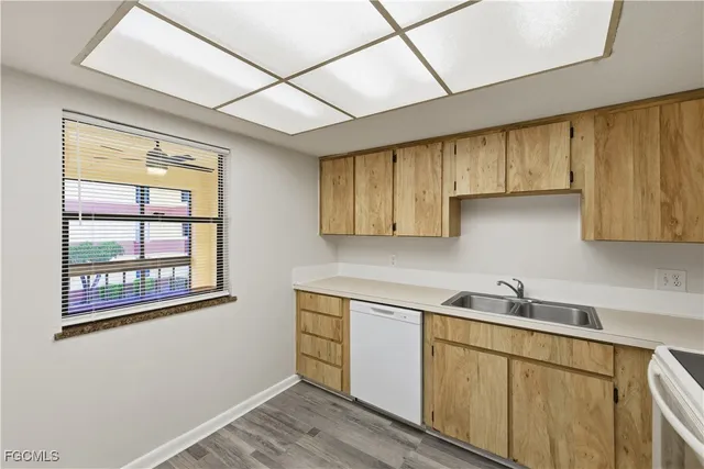 a kitchen with stainless steel appliances cabinets a large window and a sink