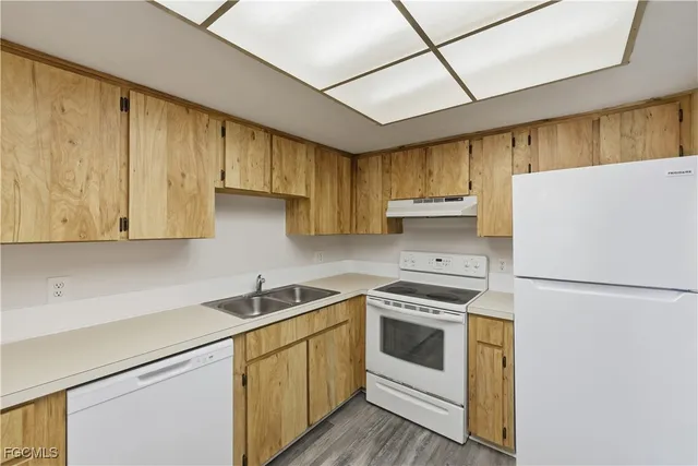 a kitchen with a white cabinets and white appliances