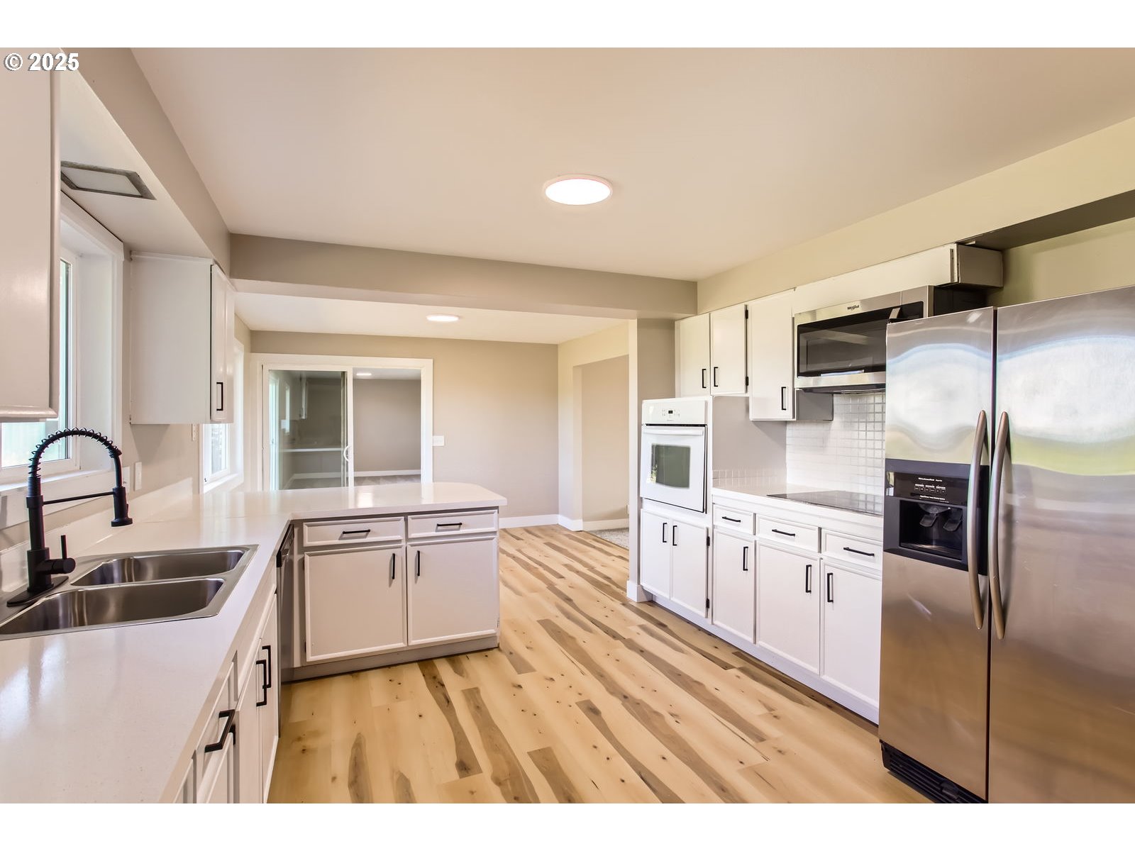 3131 Highway 47 Forest Grove, OR 97116 - Photo 14 of 30 a kitchen with granite countertop a sink stove refrigerator and cabinets