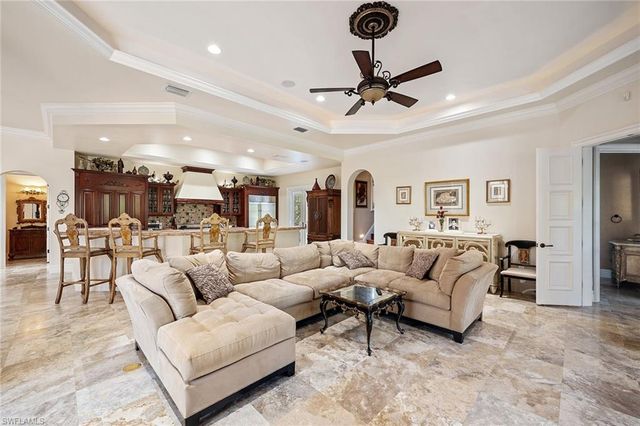 a living room with furniture and a ceiling fan