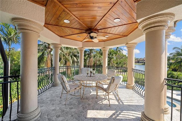 a view of a patio with a dining table and chairs