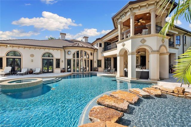 a front view of a house with swimming pool having outdoor seating