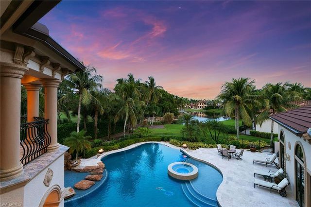 a view of a swimming pool with lounge chairs in patio
