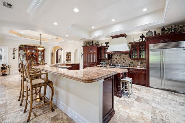 a kitchen with stainless steel appliances kitchen island granite countertop a sink and cabinets