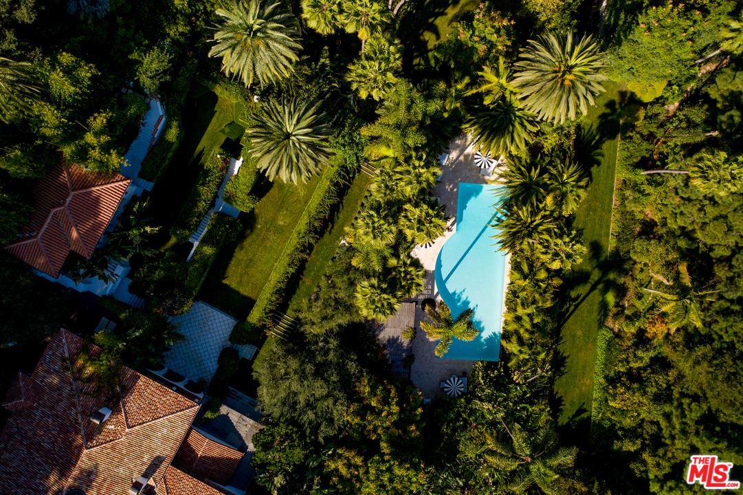 an aerial view of residential houses with yard