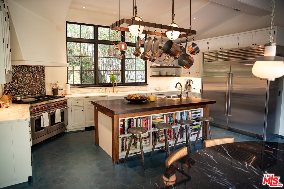 609 East Channel Road Santa Monica, CA 90402 - Photo 22 of 31 a kitchen with stainless steel appliances granite countertop a stove and a refrigerator