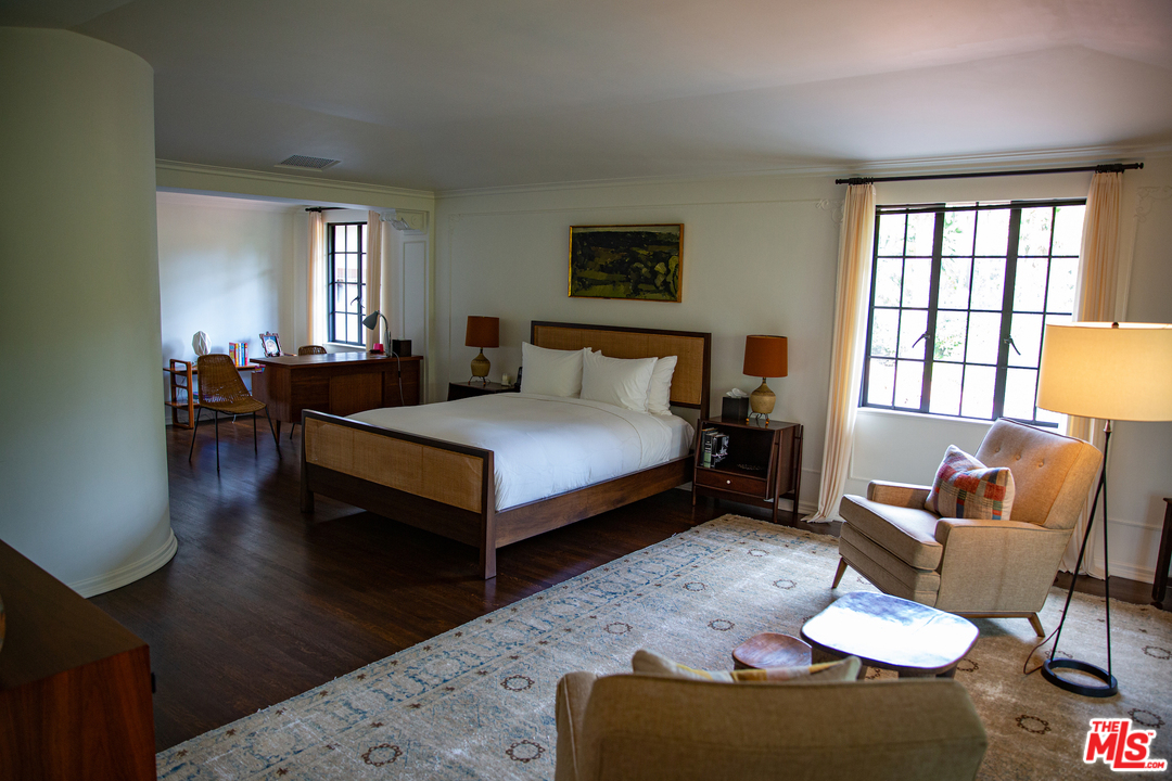 609 East Channel Road Santa Monica, CA 90402 - Photo 23 of 31 a bedroom with a bed and wooden floor