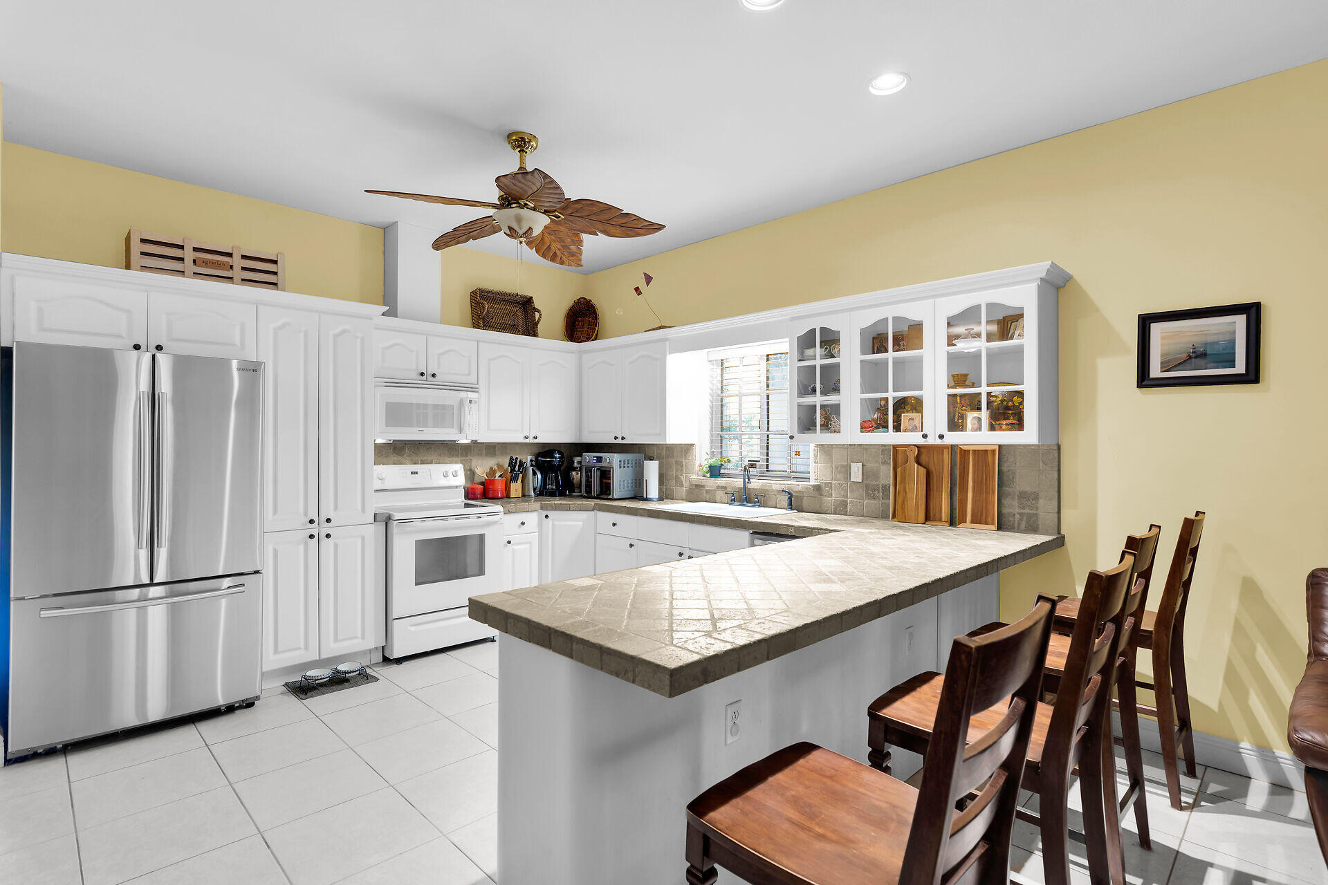 6 Fishermans Trail Key Largo, FL 33037 - Photo 11 of 41 a kitchen with stainless steel appliances granite countertop a table chairs and refrigerator
