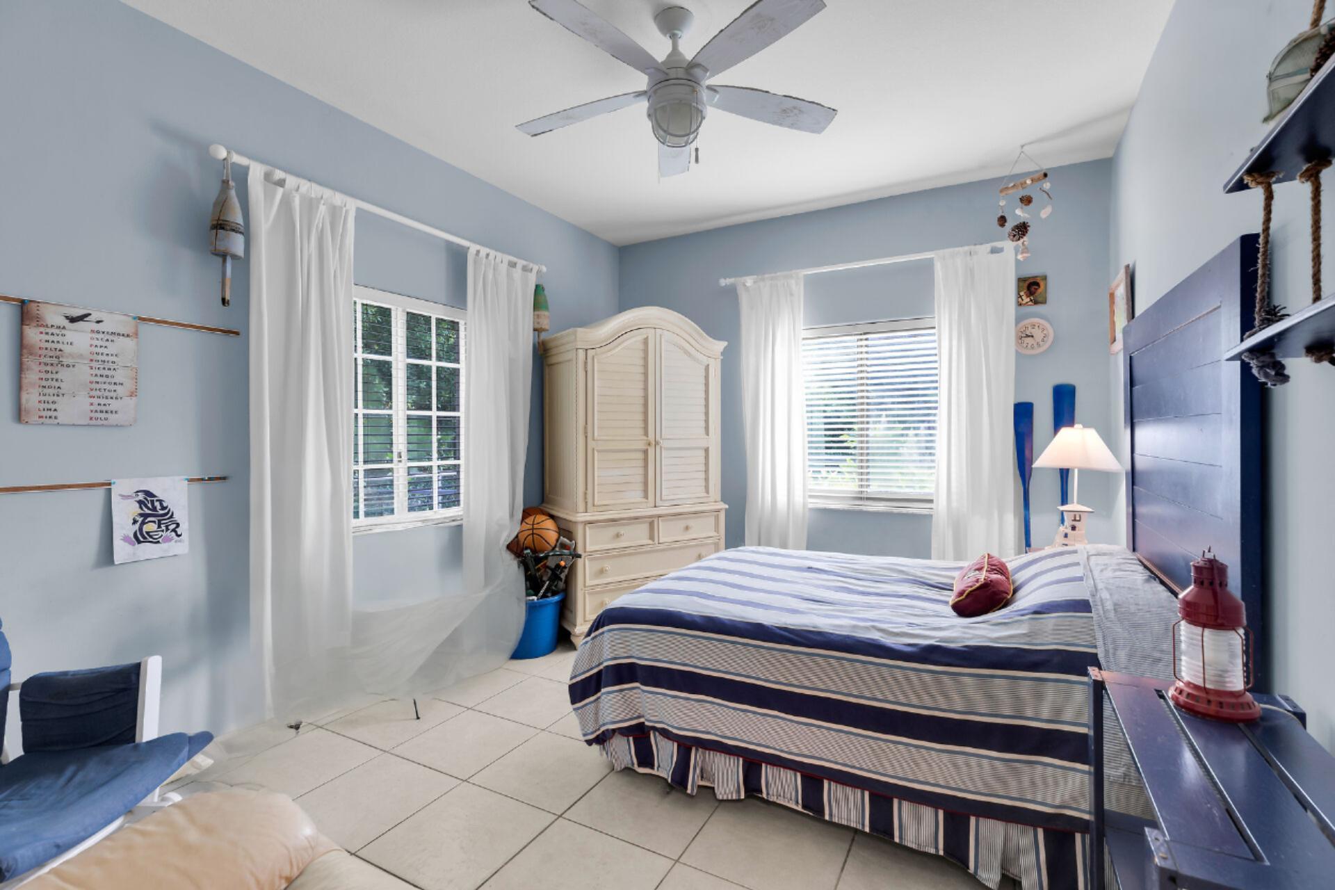 6 Fishermans Trail Key Largo, FL 33037 - Photo 19 of 41 a bedroom with a bed a window and potted plant