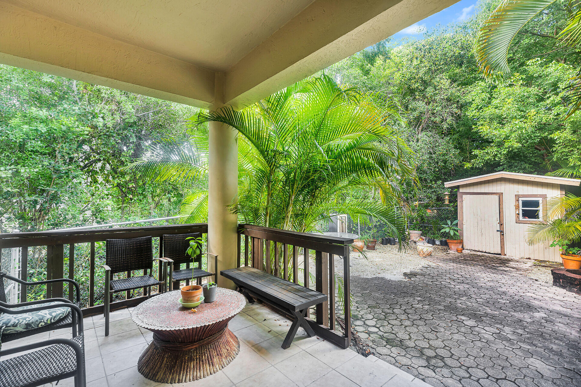 6 Fishermans Trail Key Largo, FL 33037 - Photo 27 of 41 a view of a patio with a table and chairs and floor to ceiling window