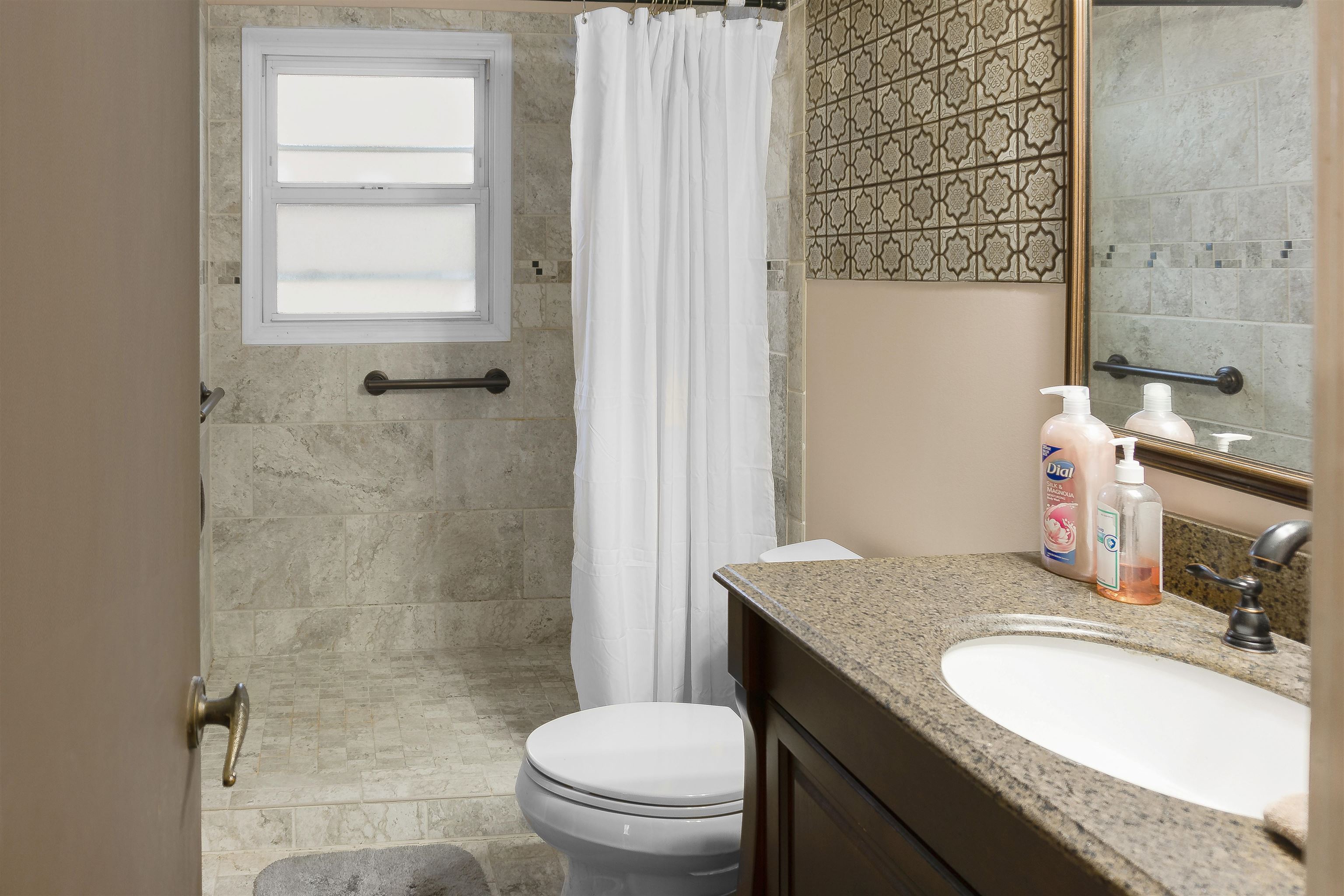 4508 Yale Road Memphis, TN 38128 - Photo 10 of 19 a bathroom with a granite countertop sink toilet a mirror and shower