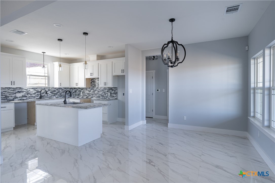 1000 Black Ankle Road Lockhart, TX 78644 - Photo 9 of 40 a kitchen with stainless steel appliances granite countertop a white cabinets sink and window