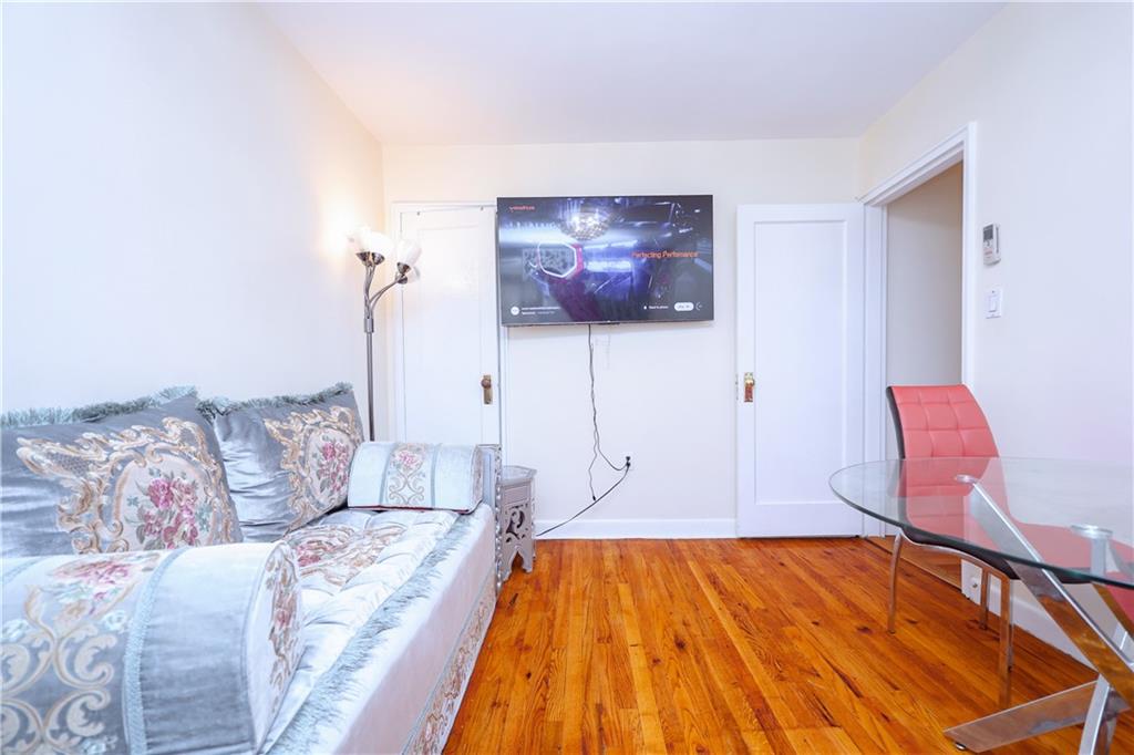 8844 18th Avenue Brooklyn, NY 11214 - Photo 13 of 19 a bedroom with a bed and a couch