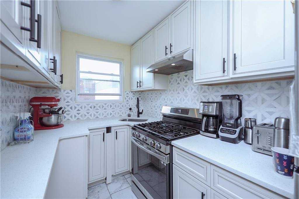 8844 18th Avenue Brooklyn, NY 11214 - Photo 14 of 19 a kitchen with cabinets and appliances