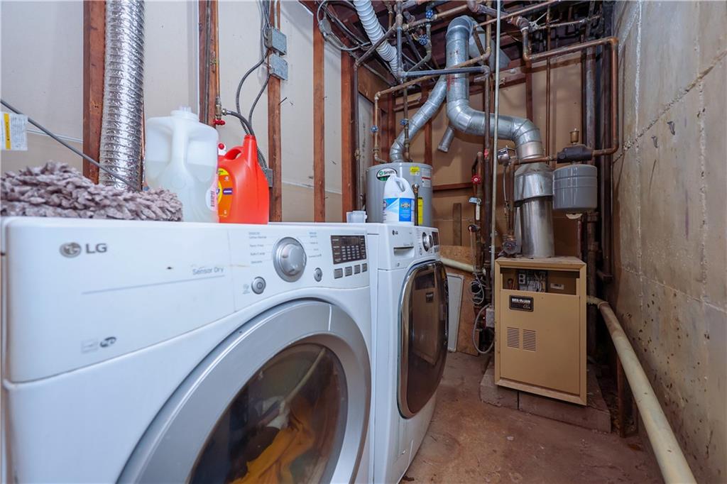 8844 18th Avenue Brooklyn, NY 11214 - Photo 18 of 19 a utility room with dryer and washer